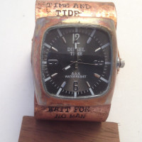 Black face tank watch on copper cuff